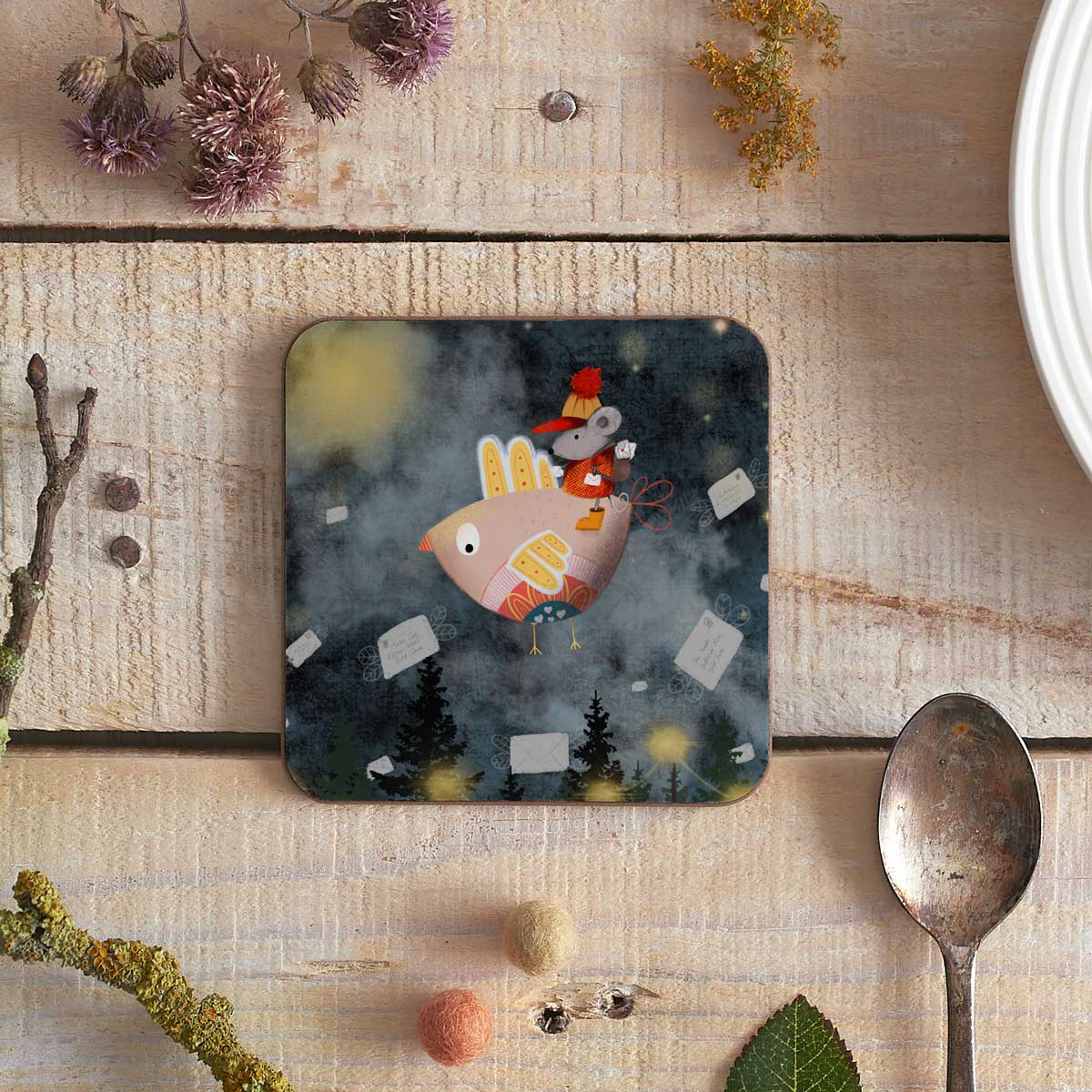 square coaster with an illustration of a birdie with mouse passenger delivering letters