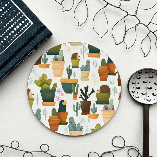 circular coaster with an illustration of hedgehogs in plant pots pretending to be cacti
