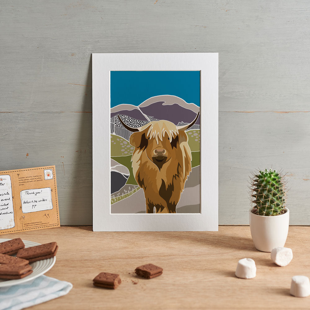 Highland cow illustration set against heather filled hills