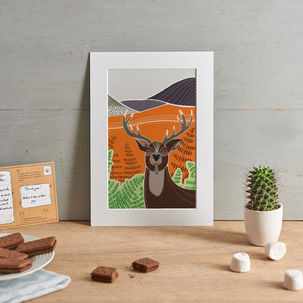Boldly coloured stag illustration shown in a home setting