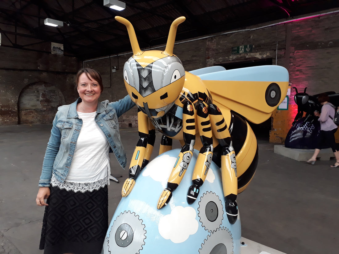 Artist Helen Russell with giant fibreglass bee painted as part of Manchester's Bee in the City public art trail