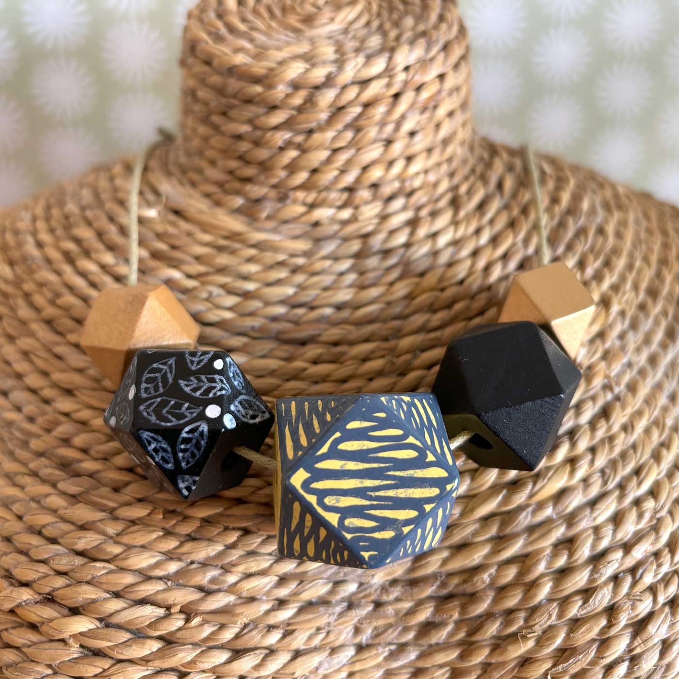 hand painted wooden necklace with grey, black and gold colouring