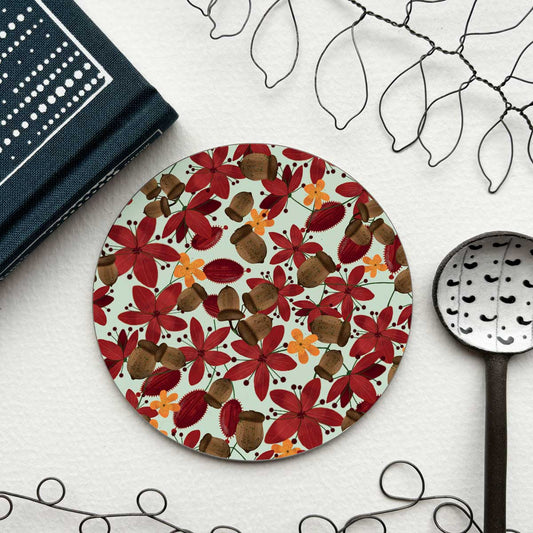circular coaster with red flowers and acorns