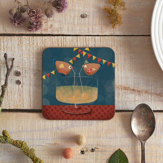 square coaster with an illustration of two birdies sharing a cocktail