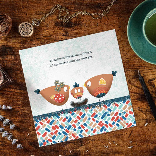 greeting card with an illustration of two Birdies and a new baby bird