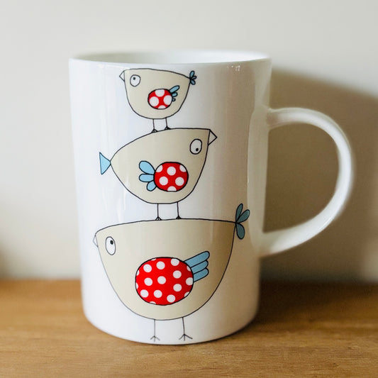 a fine china mug with birdie illustration