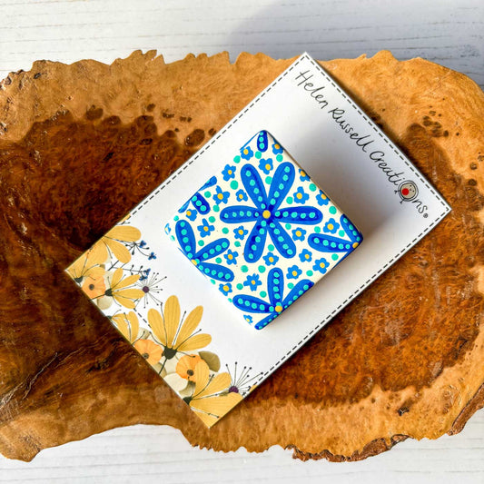 hand painted square ceramic brooch with blue floral pattern
