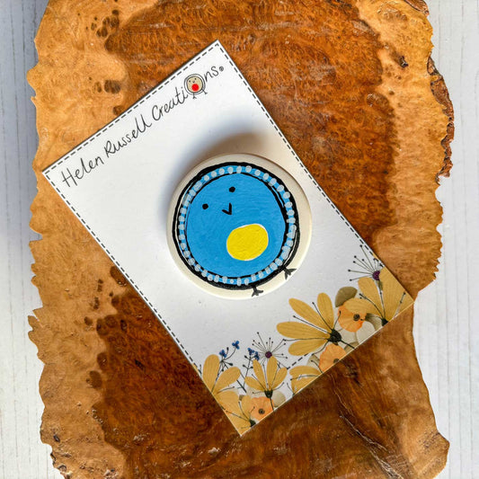 circular ceramic brooch with blue tit blob bird illustration
