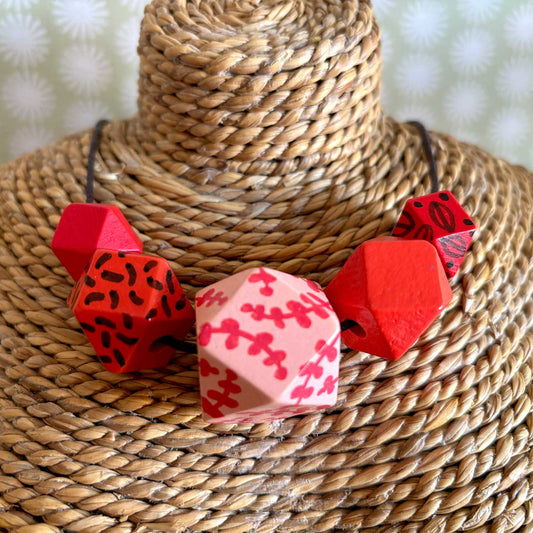 hand painted wooden necklace with cherry blossom inspired design and colours