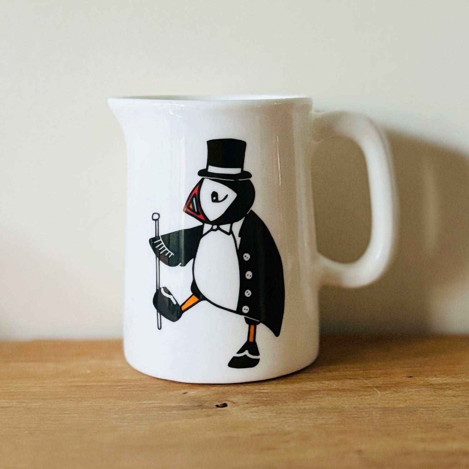 fine china mini jug with illustration of a puffin dressed up in formal attire