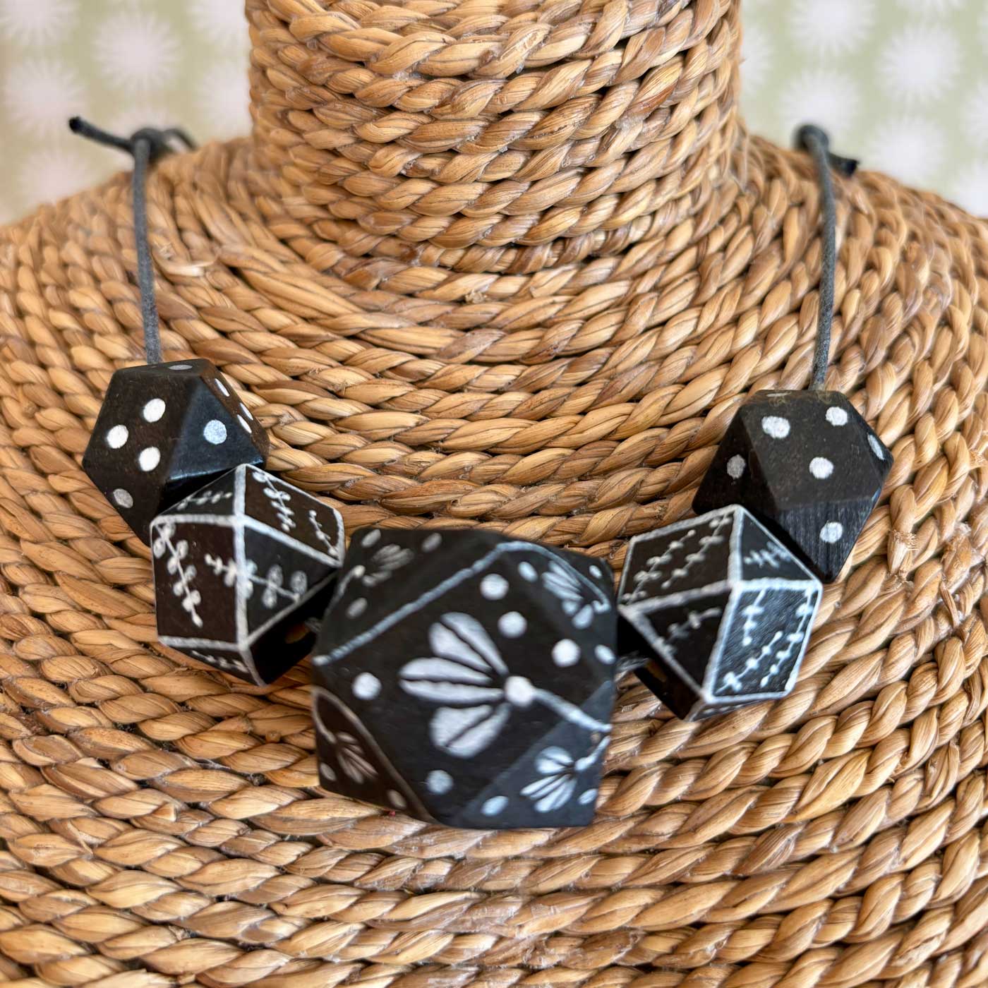 Black beaded necklace with hand illustrated white design