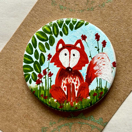 circular ceramic brooch with fox illustration