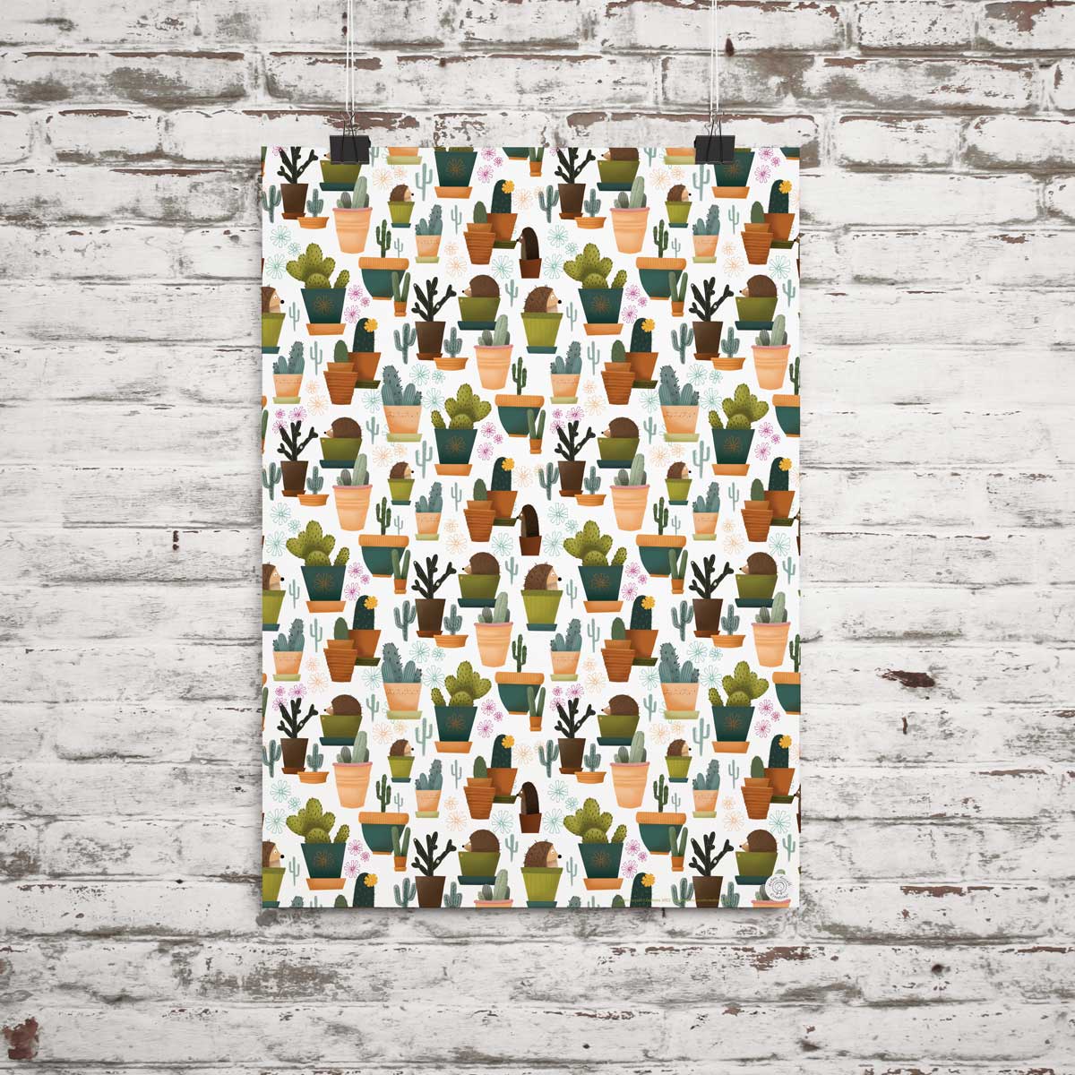 Gift wrap featuring hedgehogs hiding in plant pots pretending to be cacti