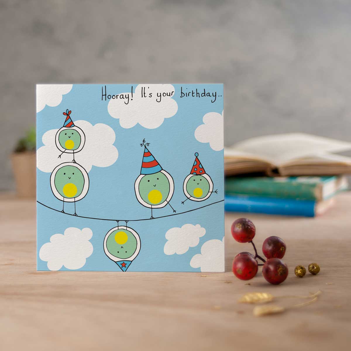 square card with blob birds stood on a washing line wearing party hats