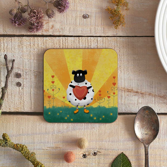 square coaster with an illustration of a sheep holding a heart