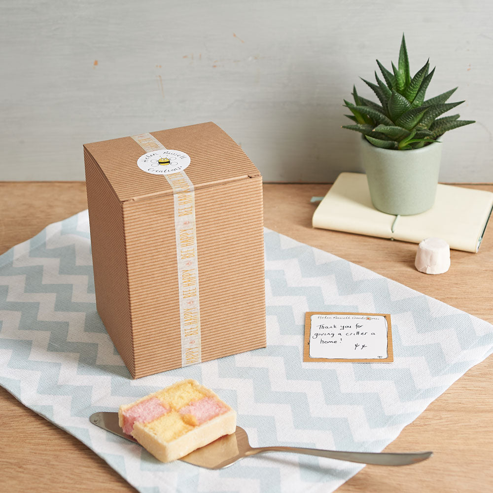 Gift box with a plant and a card on a table