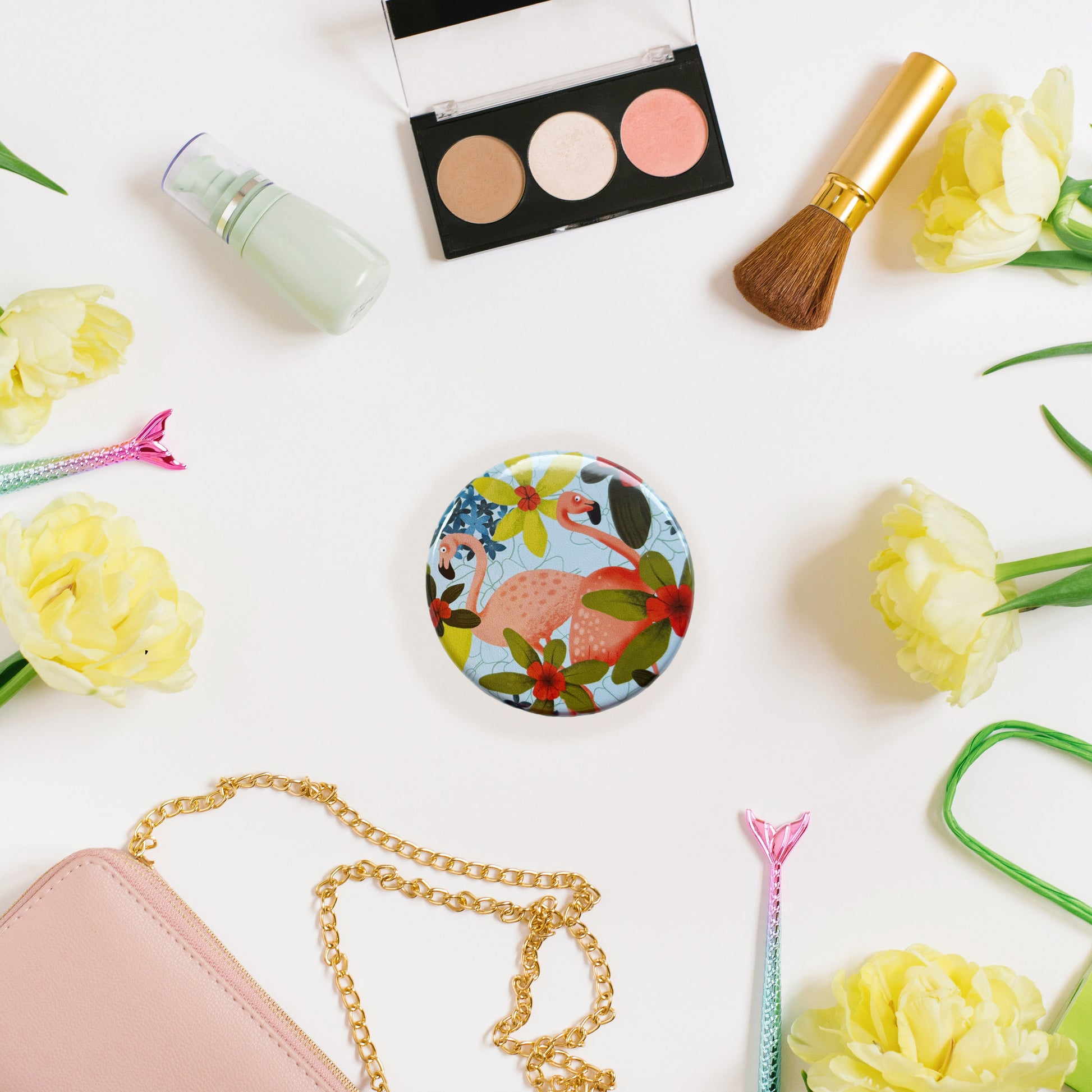 circular pocket mirror with flamingo and tropical flowers illustration
