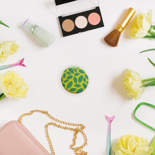 circular pocket mirror with bright and cheerful green leaf pattern