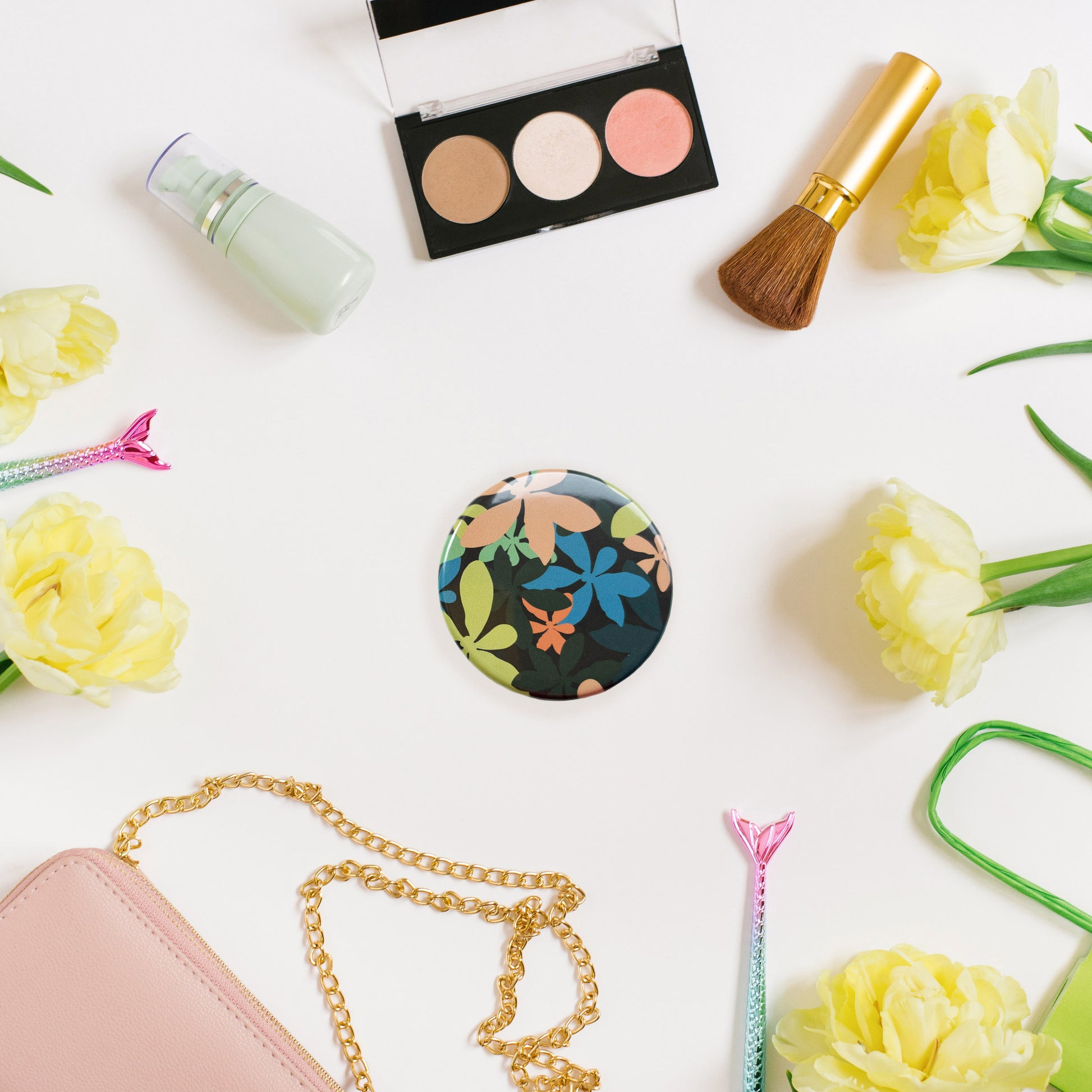 circular pocket mirror with tropical leaf pattern