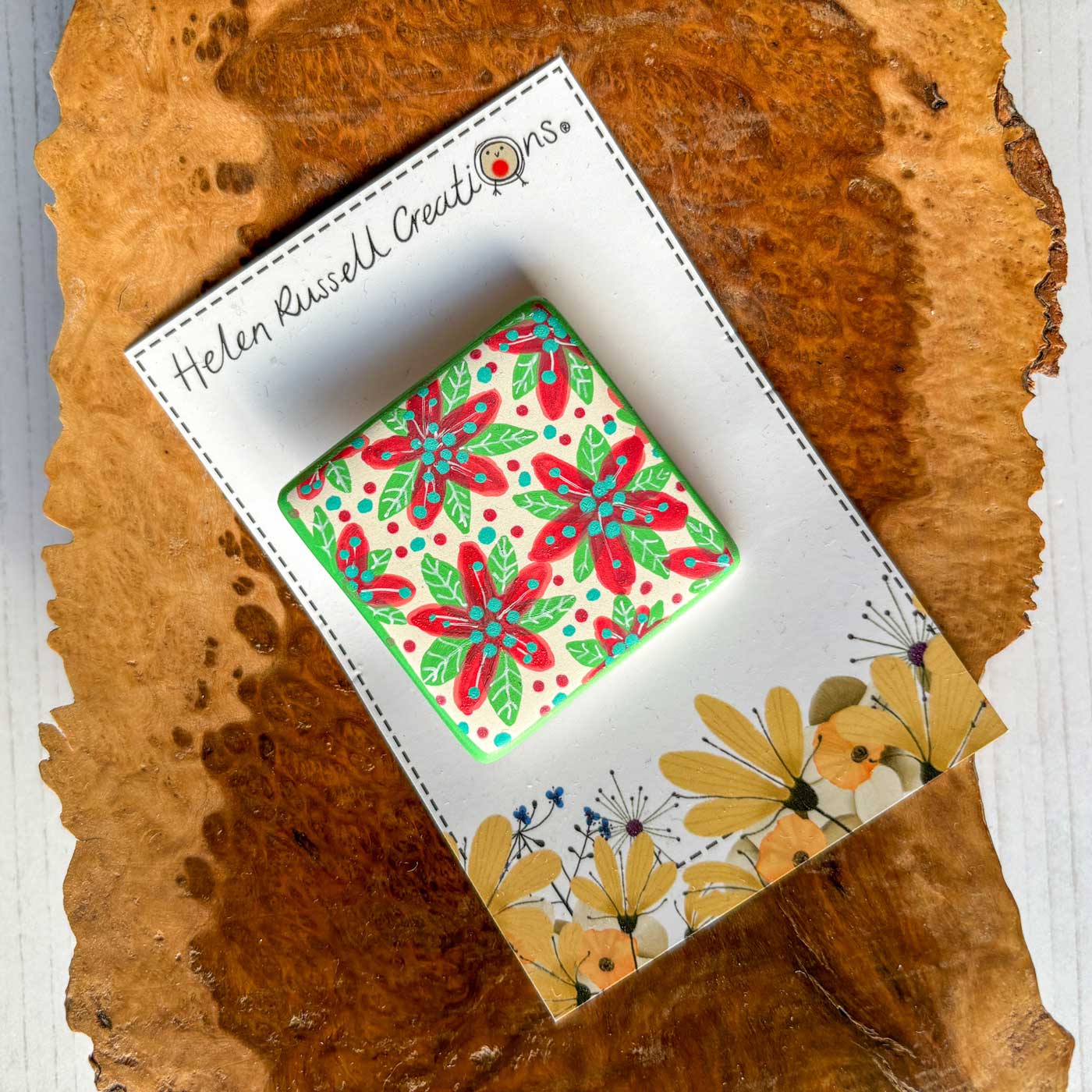 poinsettia design on a square ceramic brooch