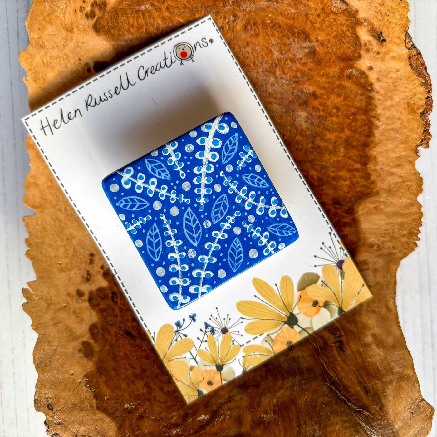 A hand painted ceramic brooch inspired by the blue and white of Spode designs