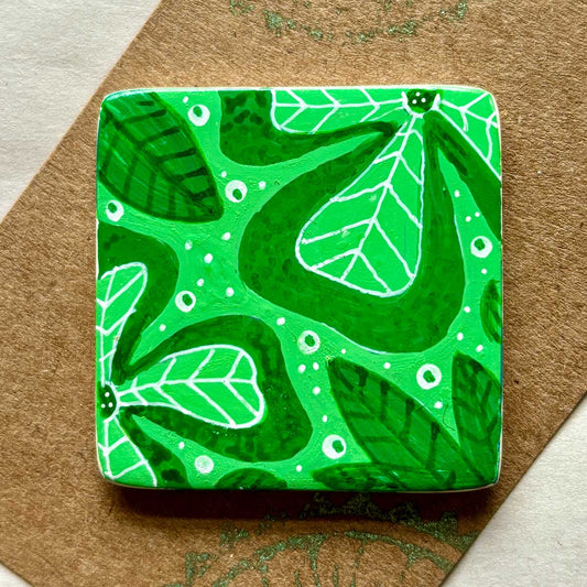 square ceramic brooch decorated with green leafy pattern