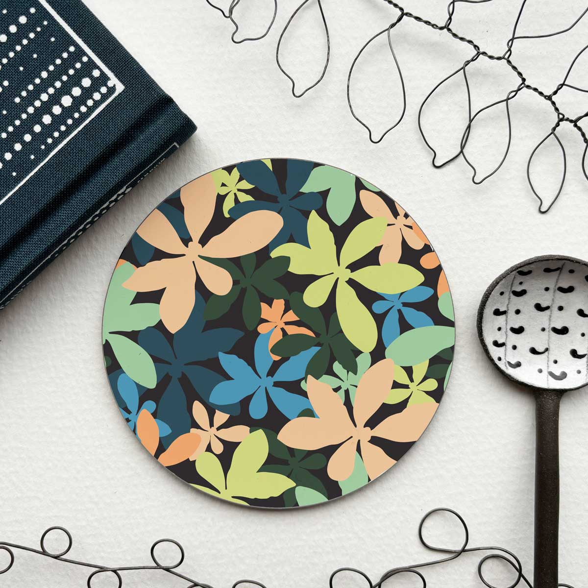 circular coaster with a colourful tropical leaf pattern