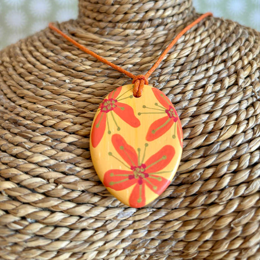 hand painted ceramic pendant with orange, red and gold flowers