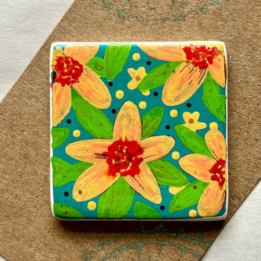 square ceramic brooch with warm floral pattern