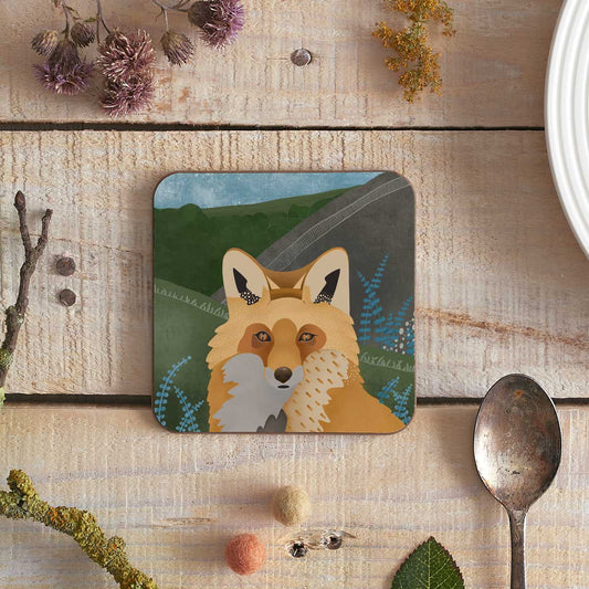 square coaster with fox illustration on a hillside