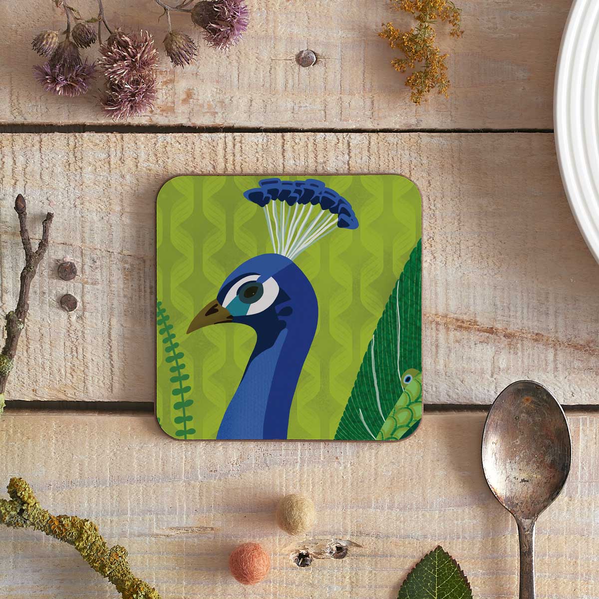 square coaster with peacock illustration