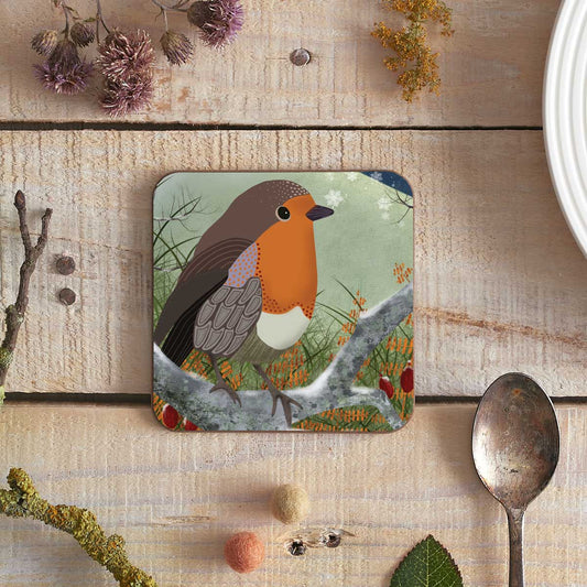 square coaster with a robin illustration catching a snowflake on its beak