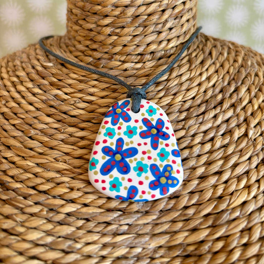 hand painted ceramic pendant with folk art inspired pattern