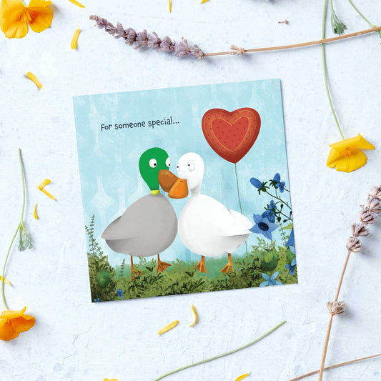 greetings card with a couple of ducks and a heart shaped balloon